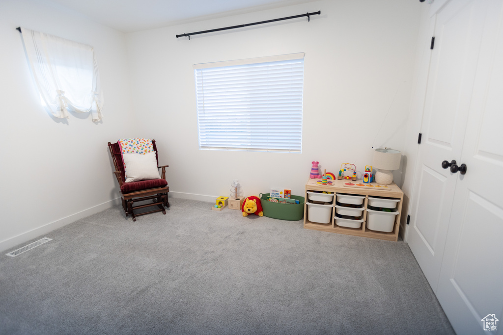 Rec room with carpet floors and baseboards