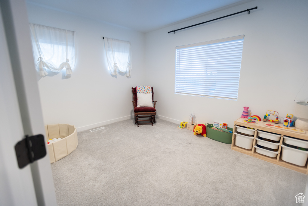 Playroom featuring carpet floors and baseboards