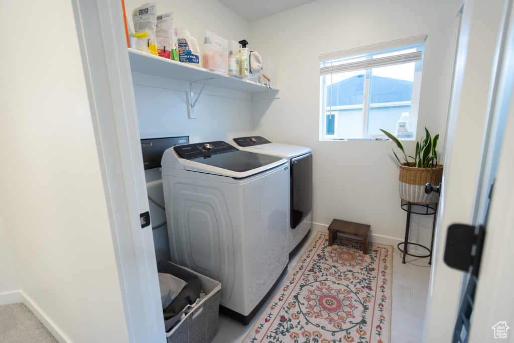 Laundry room with separate washer and dryer and baseboards