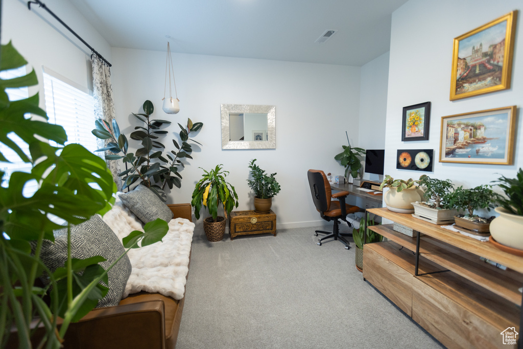Home office with carpet flooring and baseboards