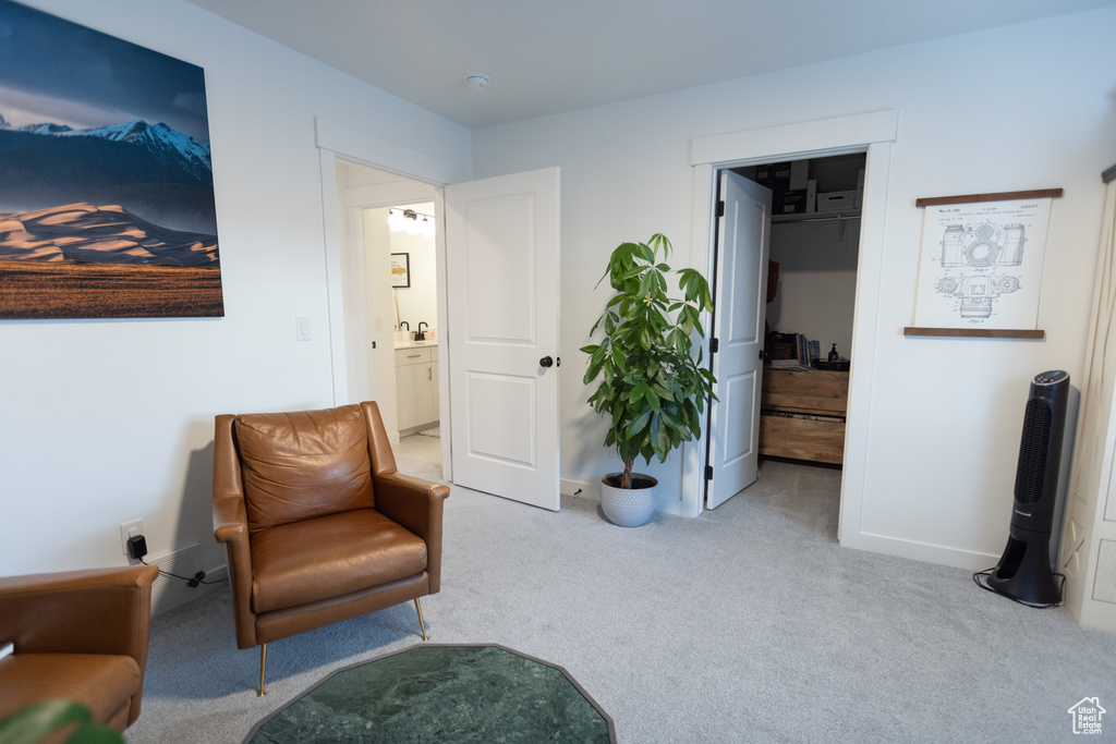 Sitting room featuring carpet and baseboards