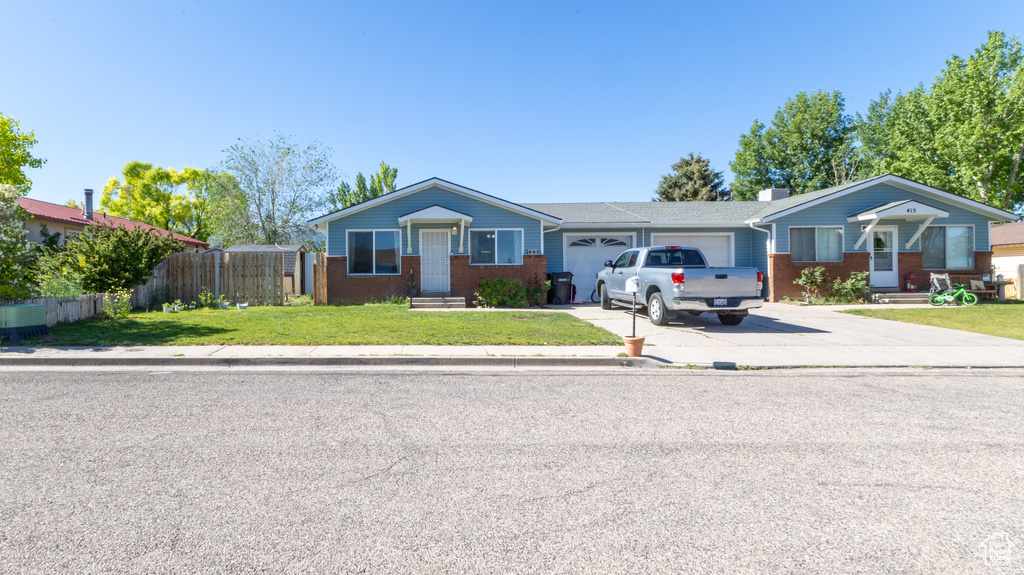 Single story home with brick siding, concrete driveway, and a garage