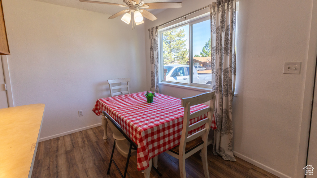 Dining room with wood finished floors, baseboards, and a ceiling fan
