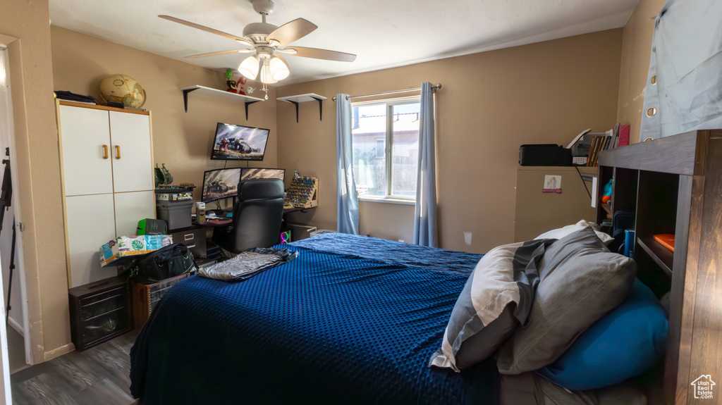 Bedroom with wood finished floors and a ceiling fan