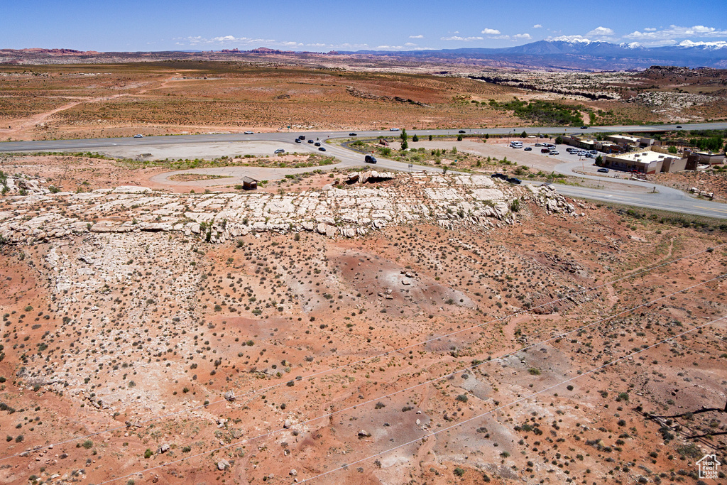Aerial view of property\'s location with a mountainous background