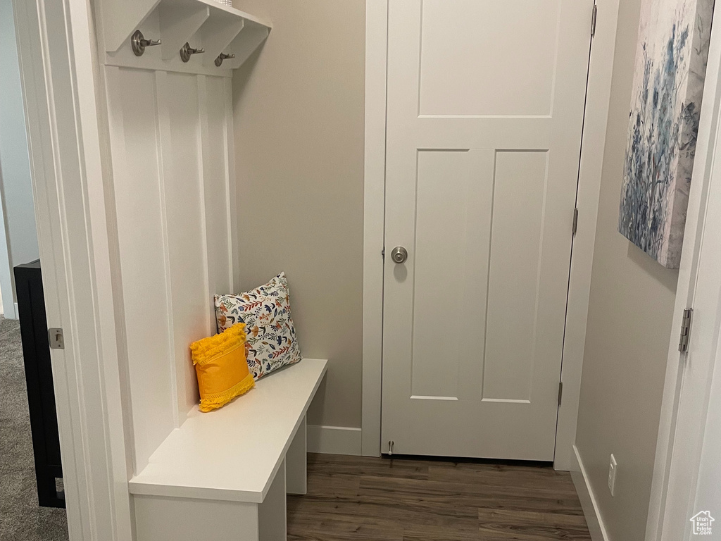 Mudroom with wood finished floors and baseboards