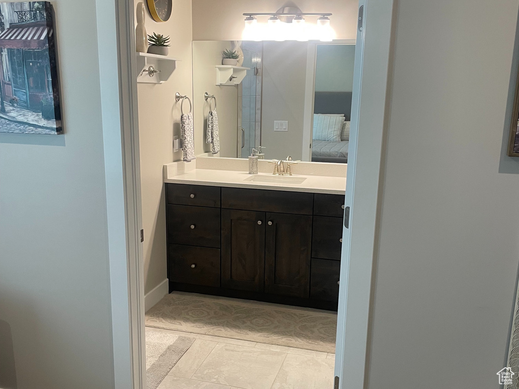 Bathroom featuring vanity, carpet flooring, and baseboards