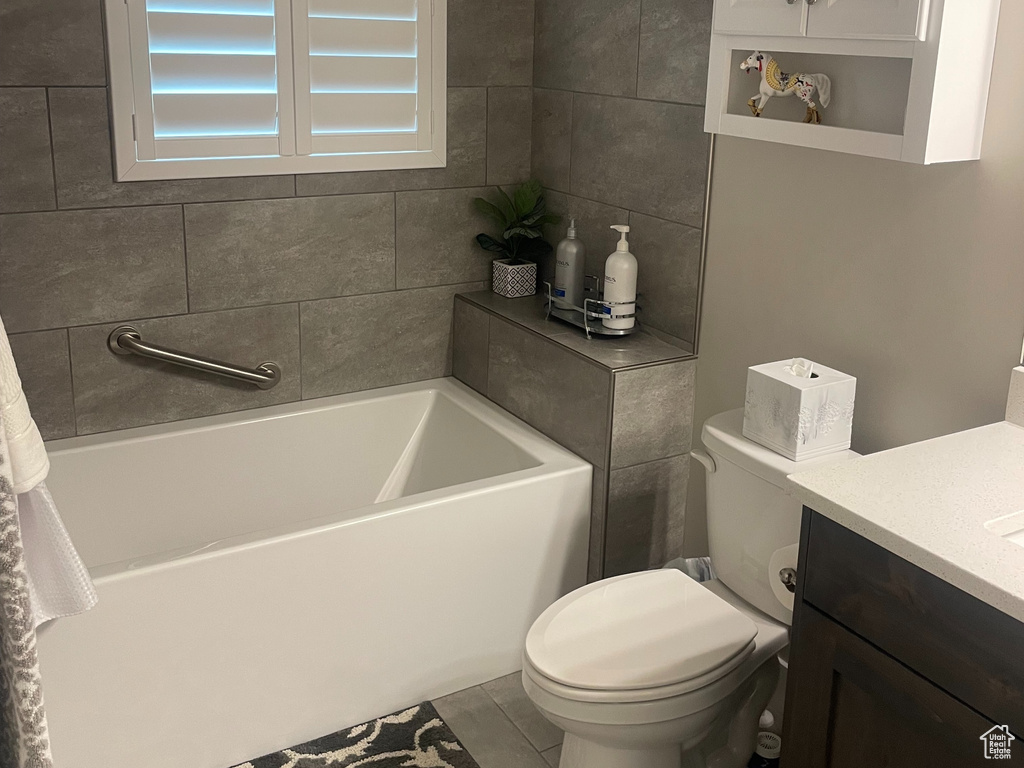 Bathroom featuring vanity, toilet, and tile patterned floors