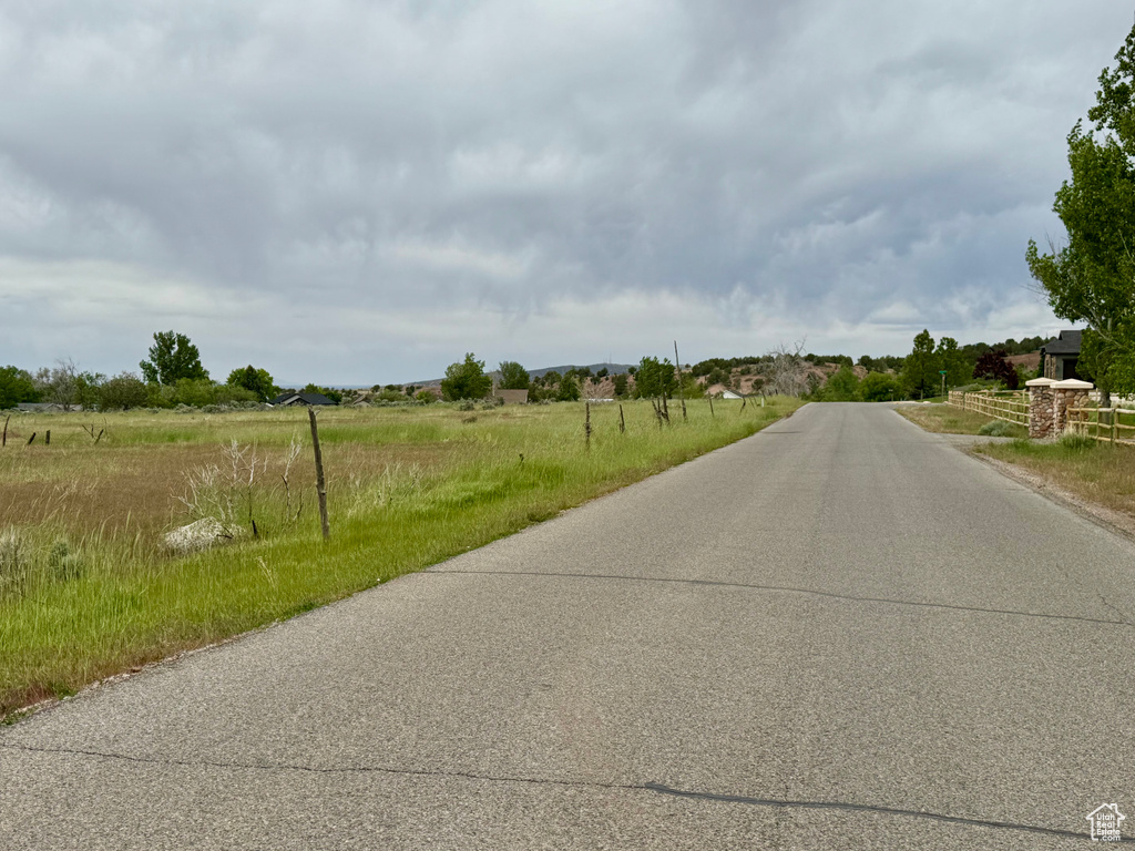 View of asphalt road with a view of rural / pastoral area