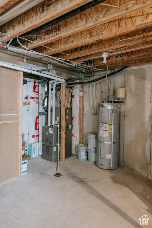 Unfinished basement featuring strapped water heater and heating unit