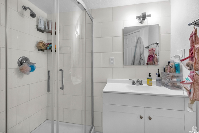 Bathroom featuring vanity and a stall shower