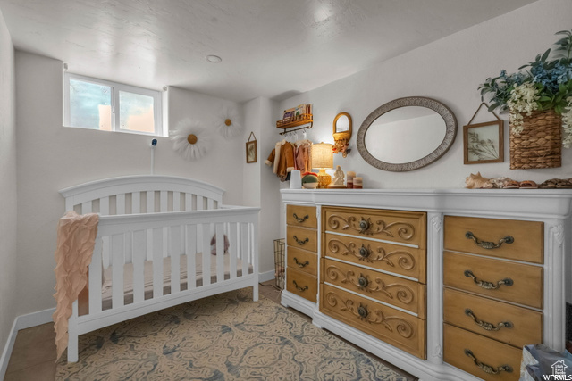 Bedroom with a nursery area and baseboards