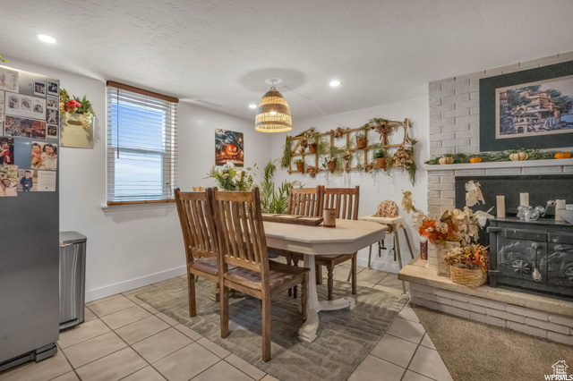 Dining room with light tile patterned floors, recessed lighting, and baseboards