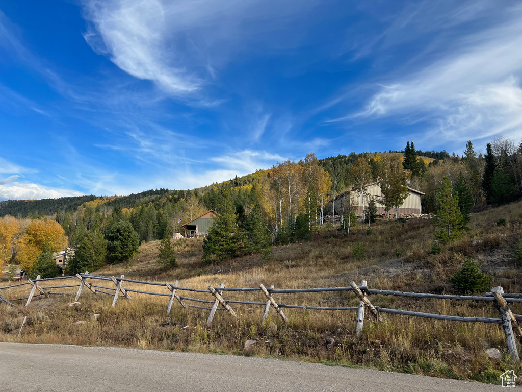 View of mountain background featuring a heavily wooded area and rural landscape