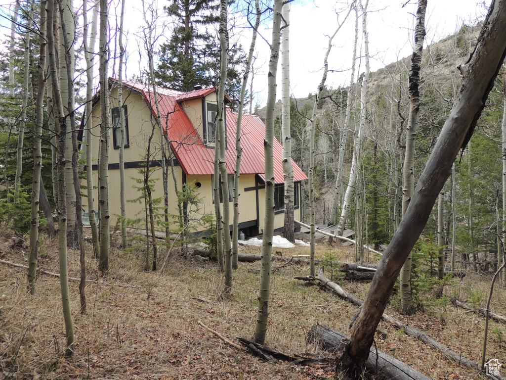 View of outbuilding with a view of trees