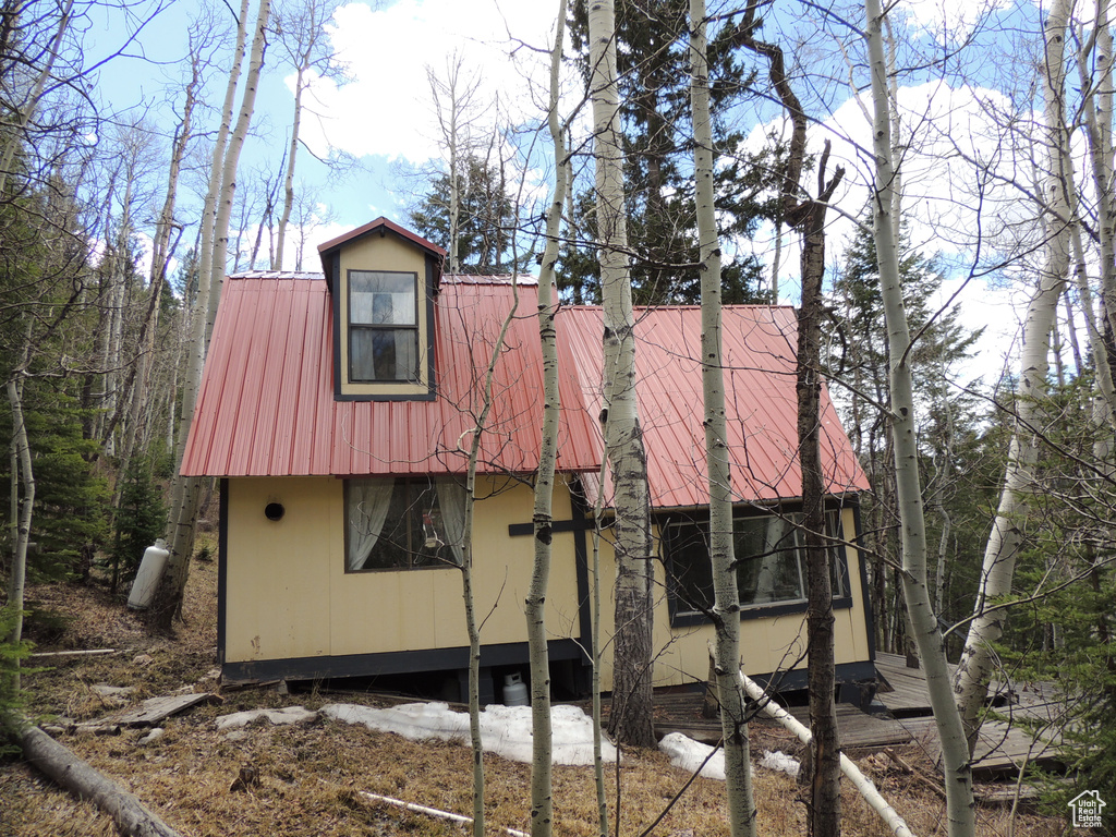 View of side of property featuring metal roof