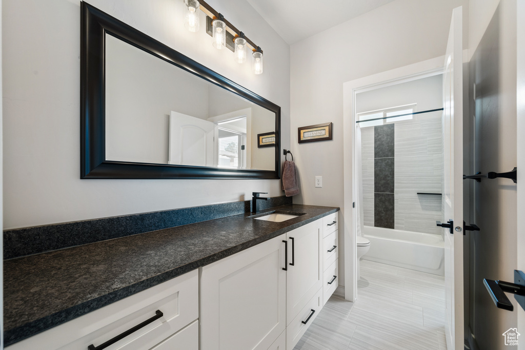 Full bath featuring vanity, toilet, and tub / shower combination