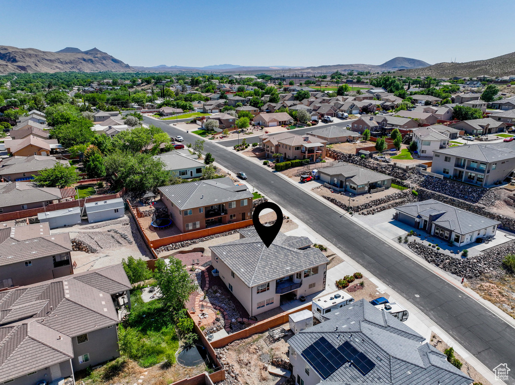 Aerial perspective of suburban area featuring a mountain backdrop