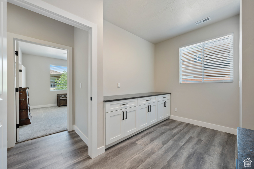 Bar with wood finished floors and baseboards