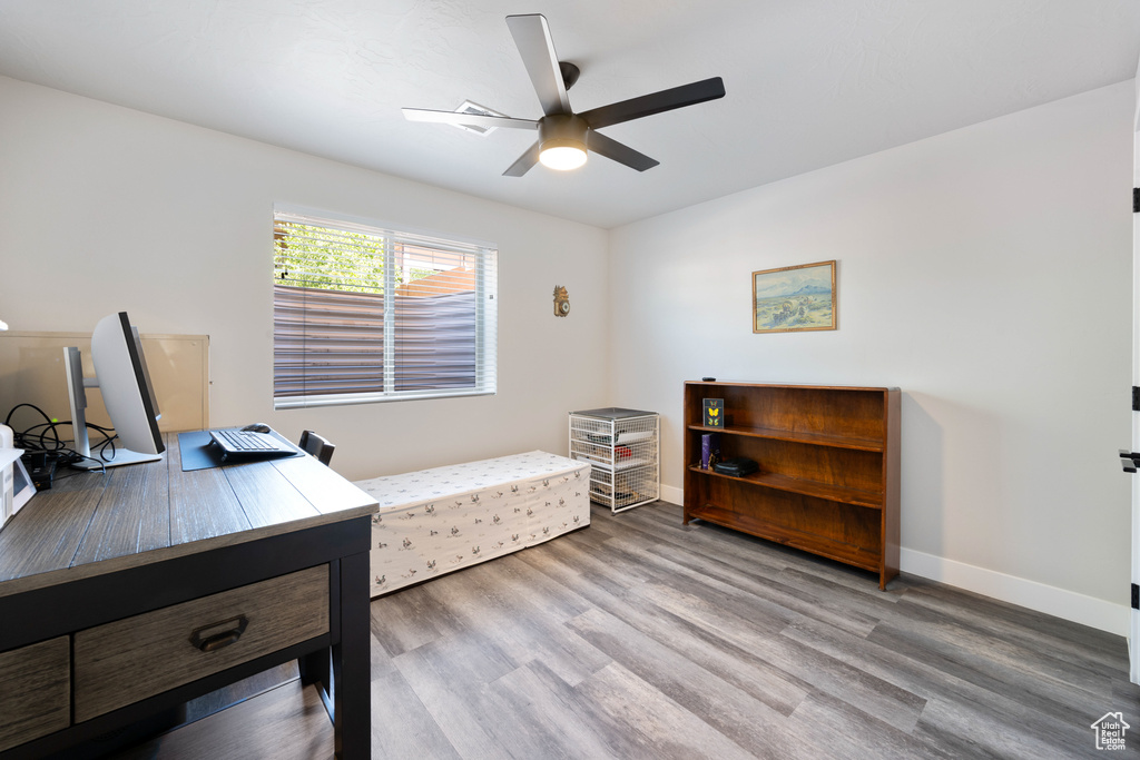 Home office featuring ceiling fan, wood finished floors, and baseboards