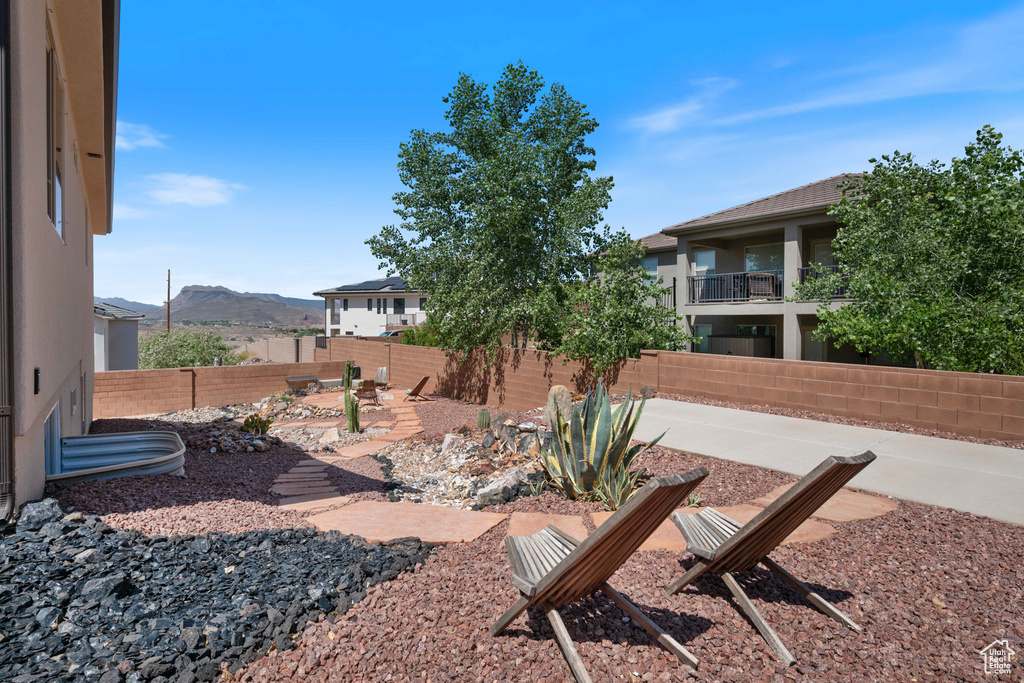 Fenced backyard with a patio and a mountain view