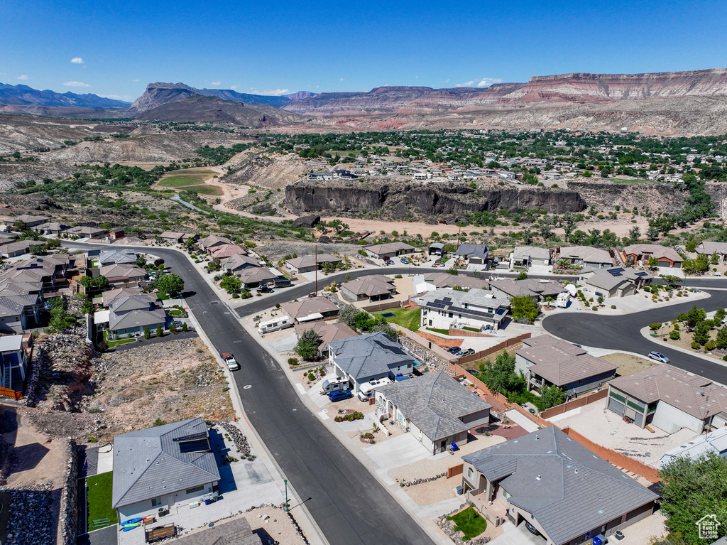 View of property location featuring mountains and nearby suburban area