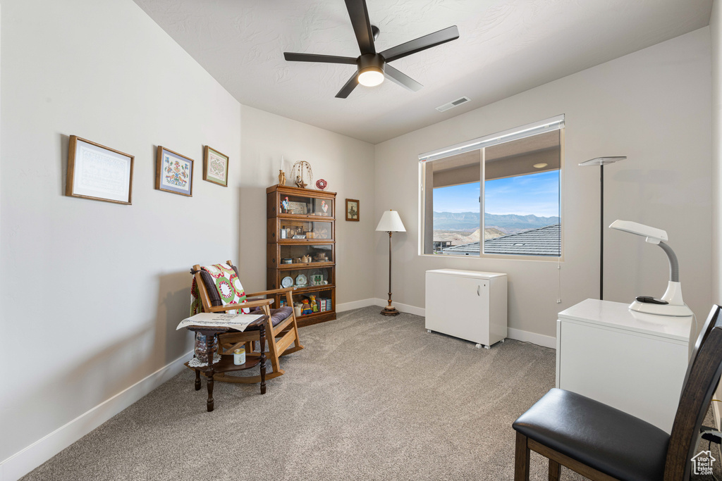 Office area featuring ceiling fan, light colored carpet, and baseboards