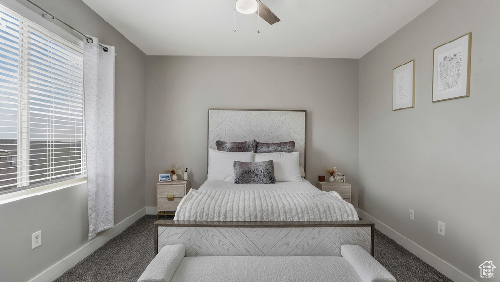 Bedroom featuring carpet flooring, baseboards, and a ceiling fan