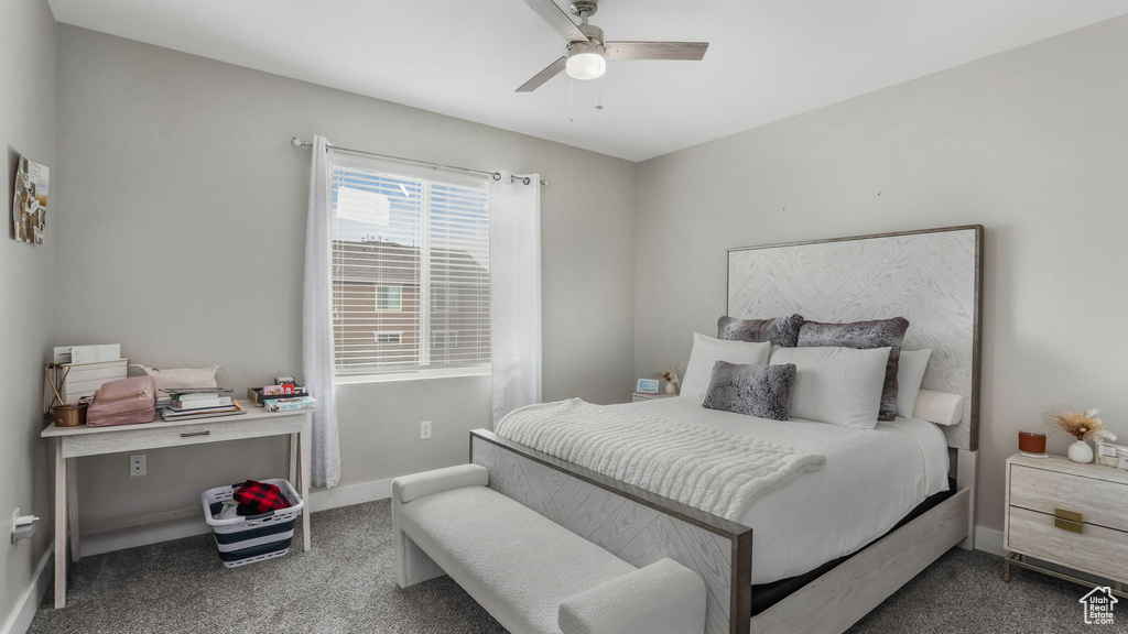 Carpeted bedroom featuring baseboards and ceiling fan