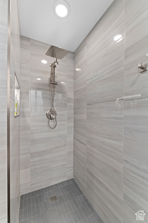 Full bath featuring a tile shower and tile patterned floors