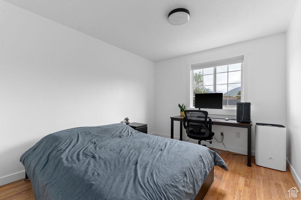 Bedroom featuring wood finished floors and baseboards