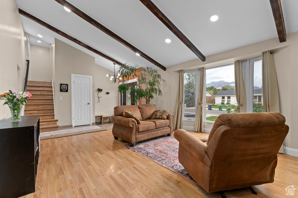 Living area with beamed ceiling, stairs, light wood-style flooring, recessed lighting, and high vaulted ceiling