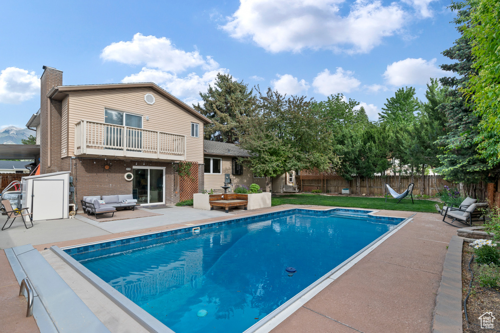 View of pool with outdoor lounge area and a patio area