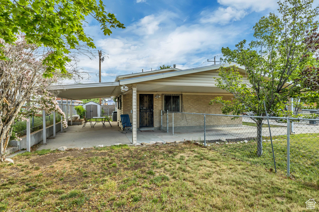 View of front of home with brick siding and an attached carport
