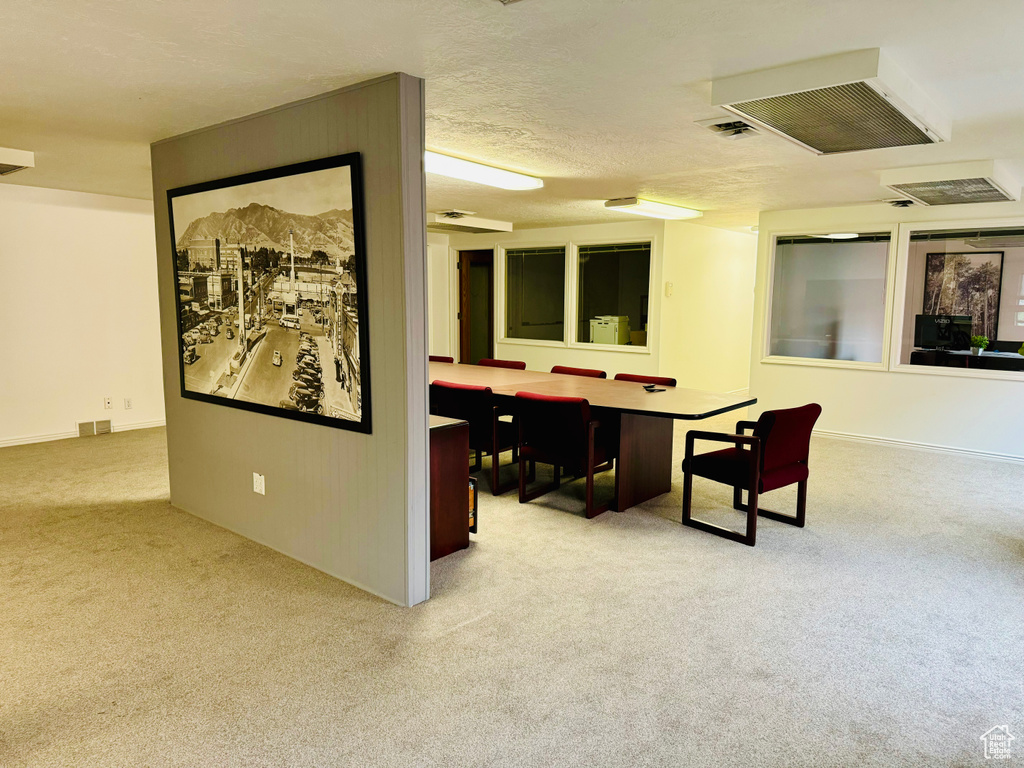 Carpeted office space with baseboards