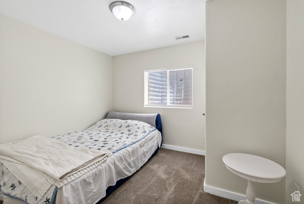 Bedroom with carpet floors and baseboards