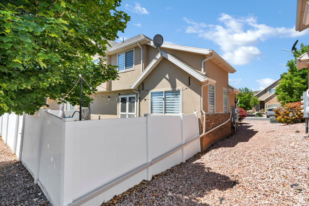 View of side of home with stucco siding and brick siding