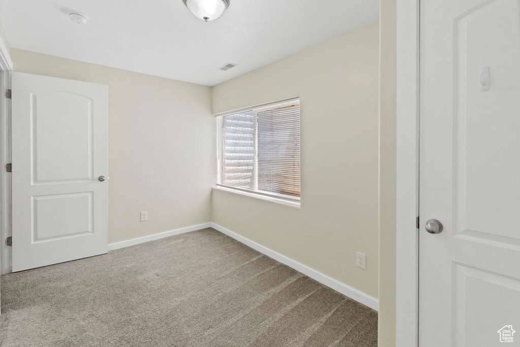 Unfurnished bedroom featuring carpet flooring and baseboards