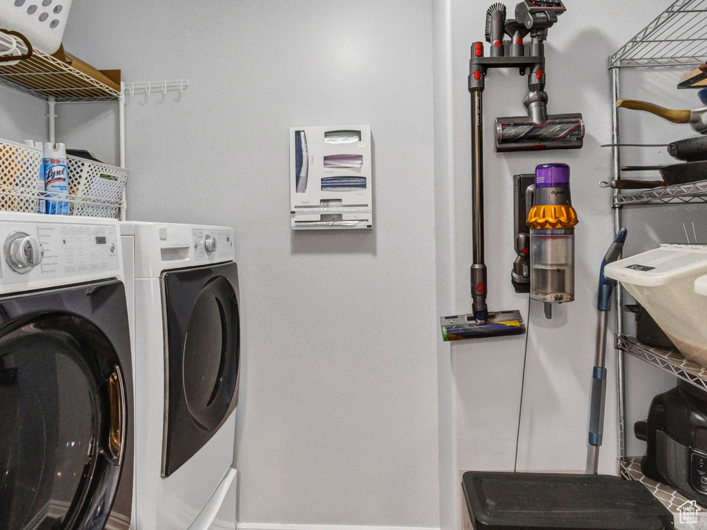 Laundry area featuring washer and dryer, wood finished floors, and baseboards