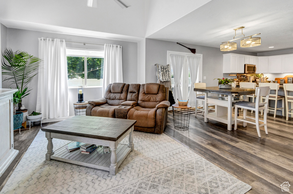 Living area with light wood-type flooring and recessed lighting