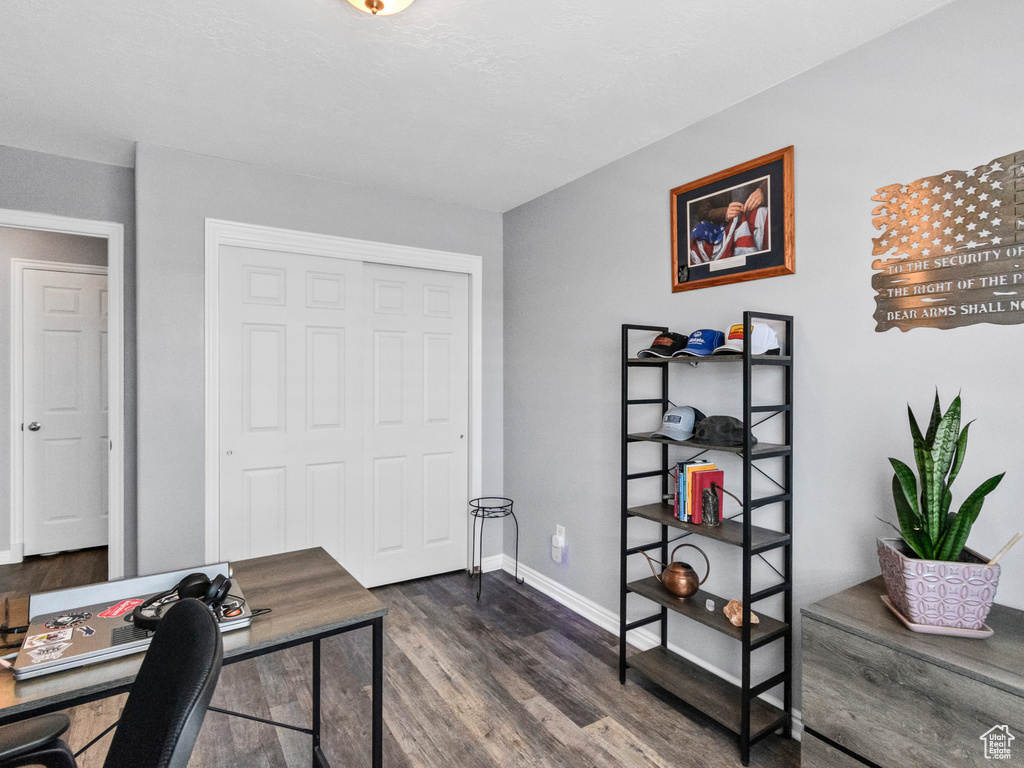Office area featuring dark wood finished floors and baseboards