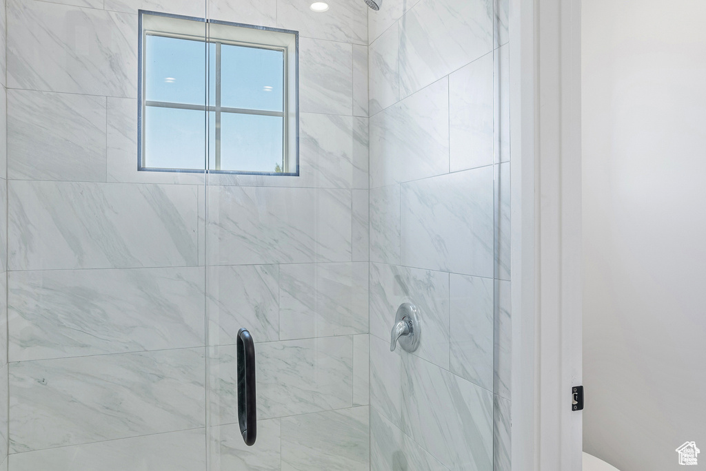 Full bathroom with a shower stall and toilet