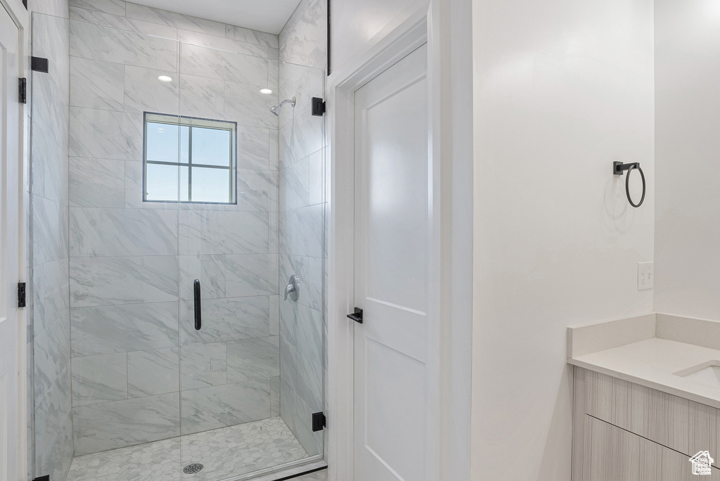 Full bath featuring a shower stall and vanity