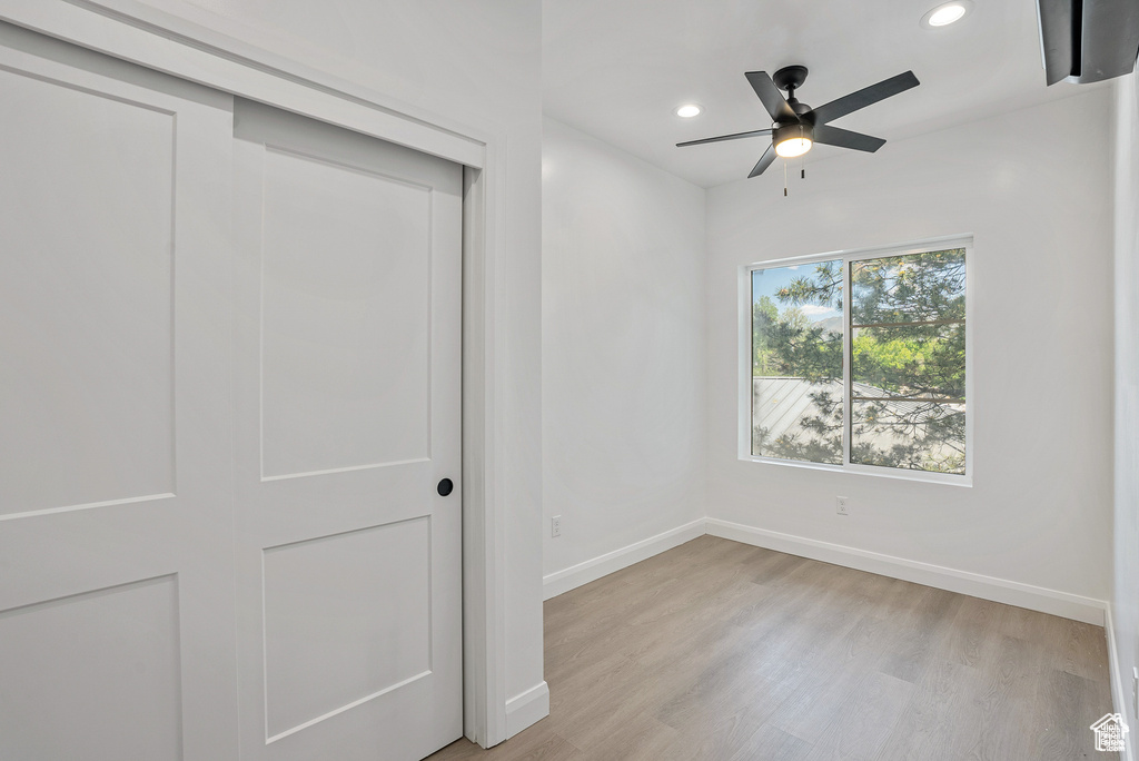 Unfurnished bedroom with light wood-style floors, baseboards, recessed lighting, a closet, and a ceiling fan
