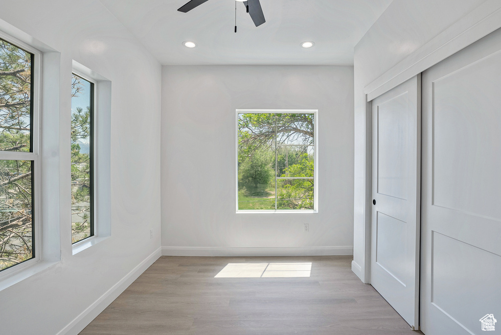 Unfurnished bedroom with baseboards, wood finished floors, recessed lighting, a closet, and a ceiling fan