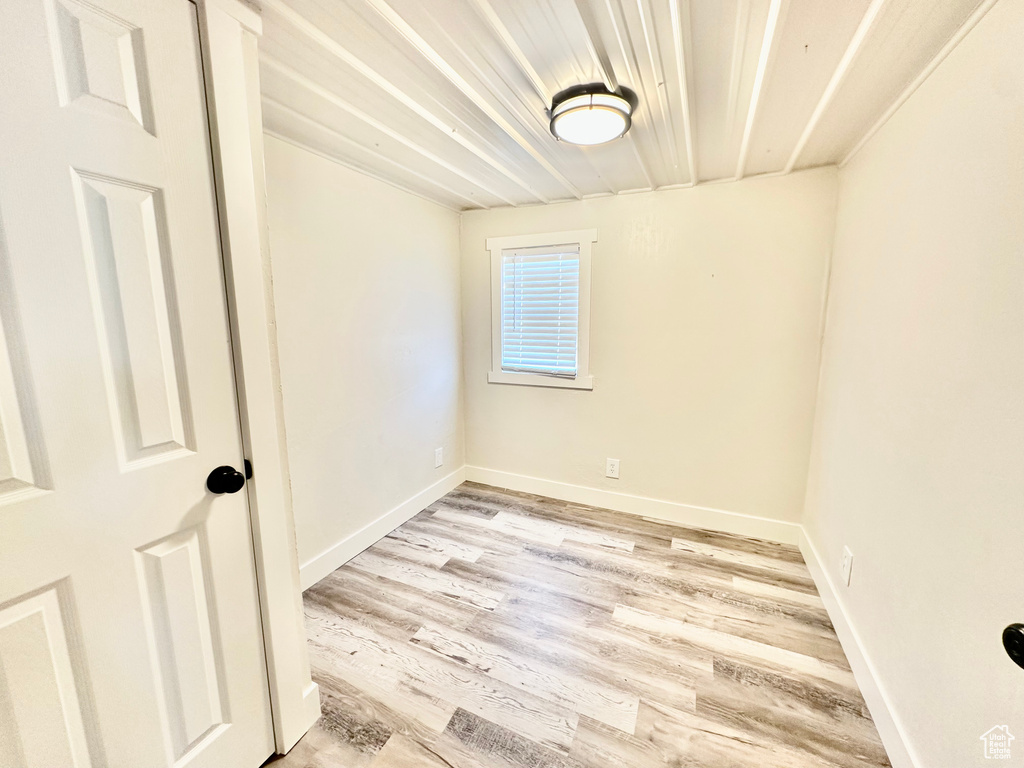 Unfurnished room with light wood-type flooring and baseboards