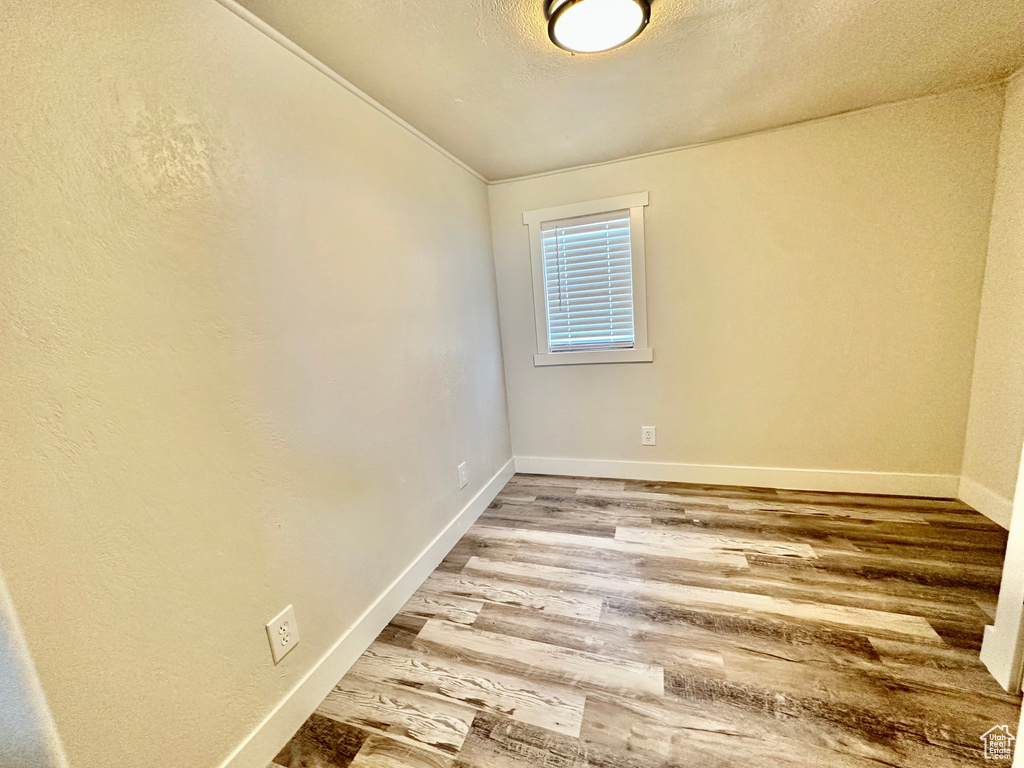 Spare room with wood finished floors and baseboards
