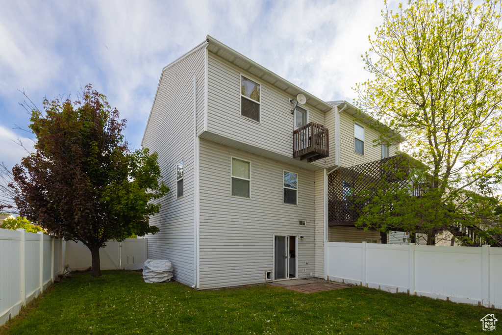 Back of house featuring a balcony