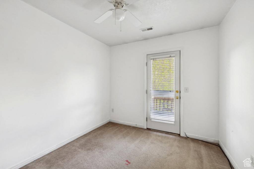Empty room with carpet floors, ceiling fan, and baseboards