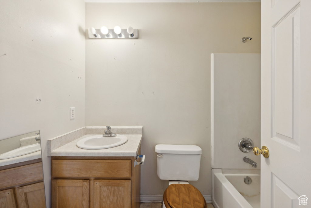 Full bathroom with vanity, toilet, and shower / washtub combination